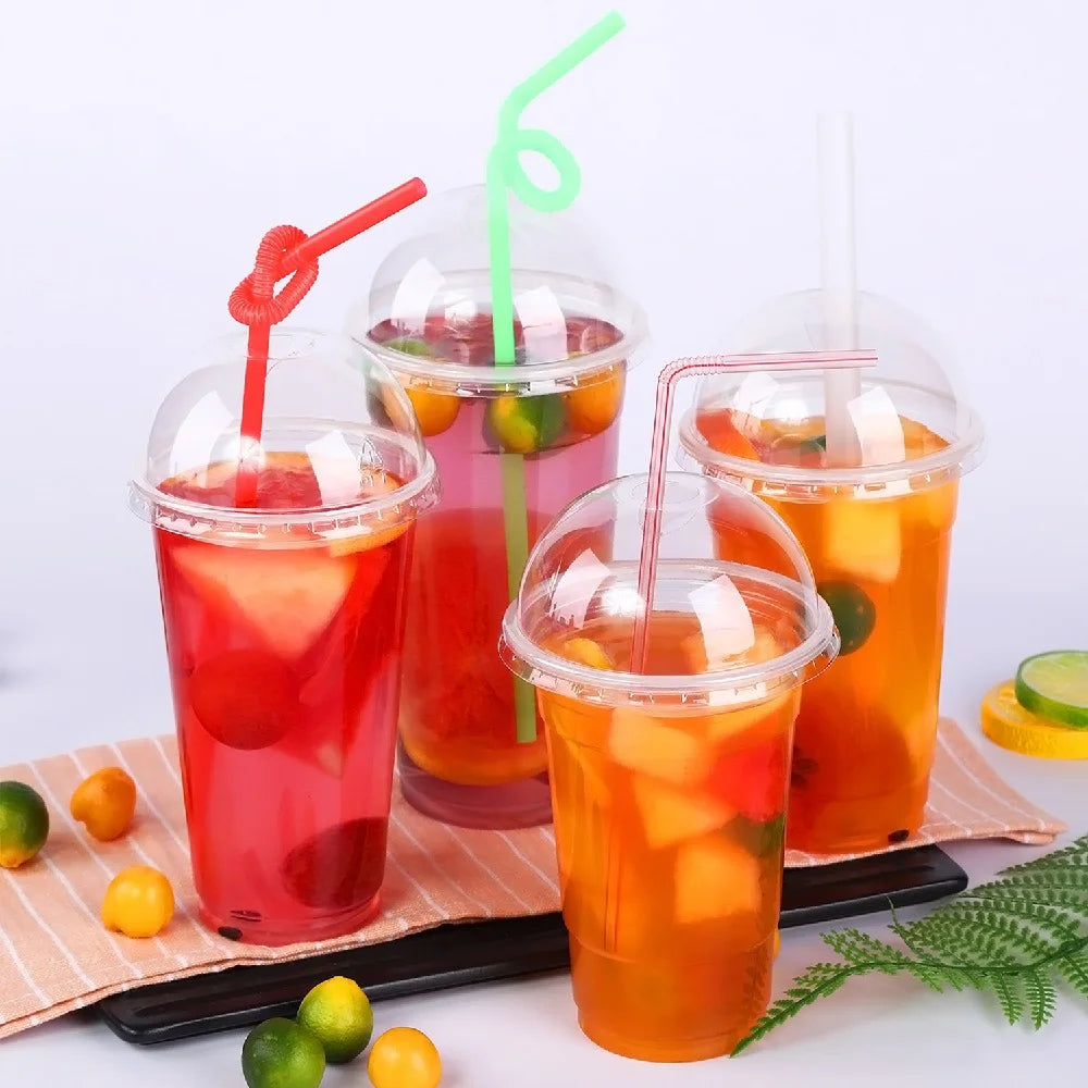 A set of disposable plastic cups with lids filled with various colored cold drinks like juice and iced tea.