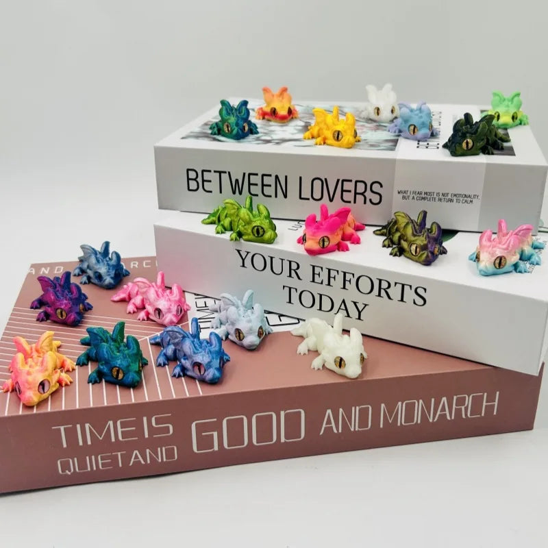 A collection of colorful articulated baby dragon figurines displayed on a wooden box.