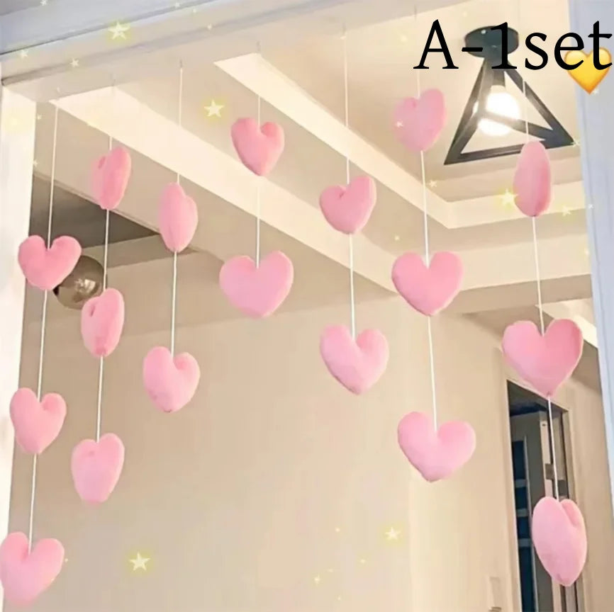 A set of pink heart and star tassel door curtain decorations hanging in a white room.