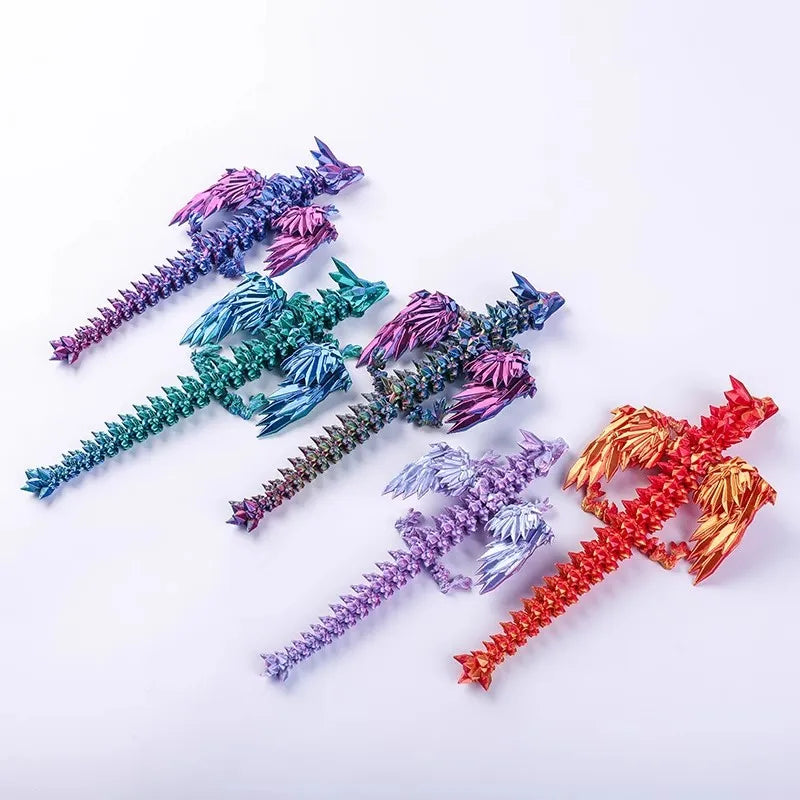 A collection of 3D printed articulated dragon fidget figurines in various colors including purple, teal, and orange.