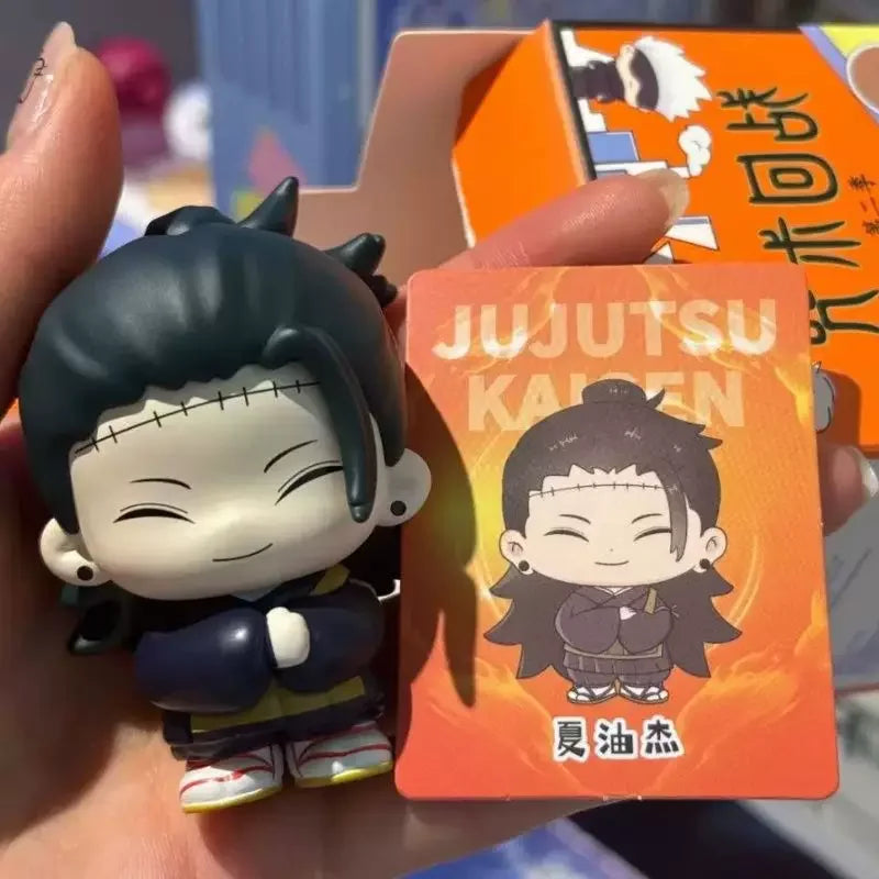 A blind box collectible featuring Jujutsu Kaisen characters Gojo and Geto in an orange packaging.