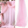 Pink sheer tulle draping fabric used as a wedding arch backdrop
