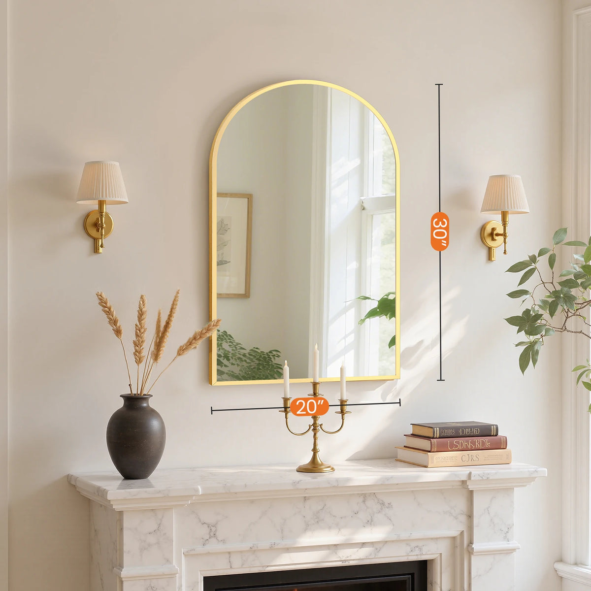 An arched wall mirror with an aluminum frame hangs above a marble fireplace mantel.