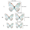 Three butterfly cake toppers in large, medium, and small sizes with varying blue and orange markings