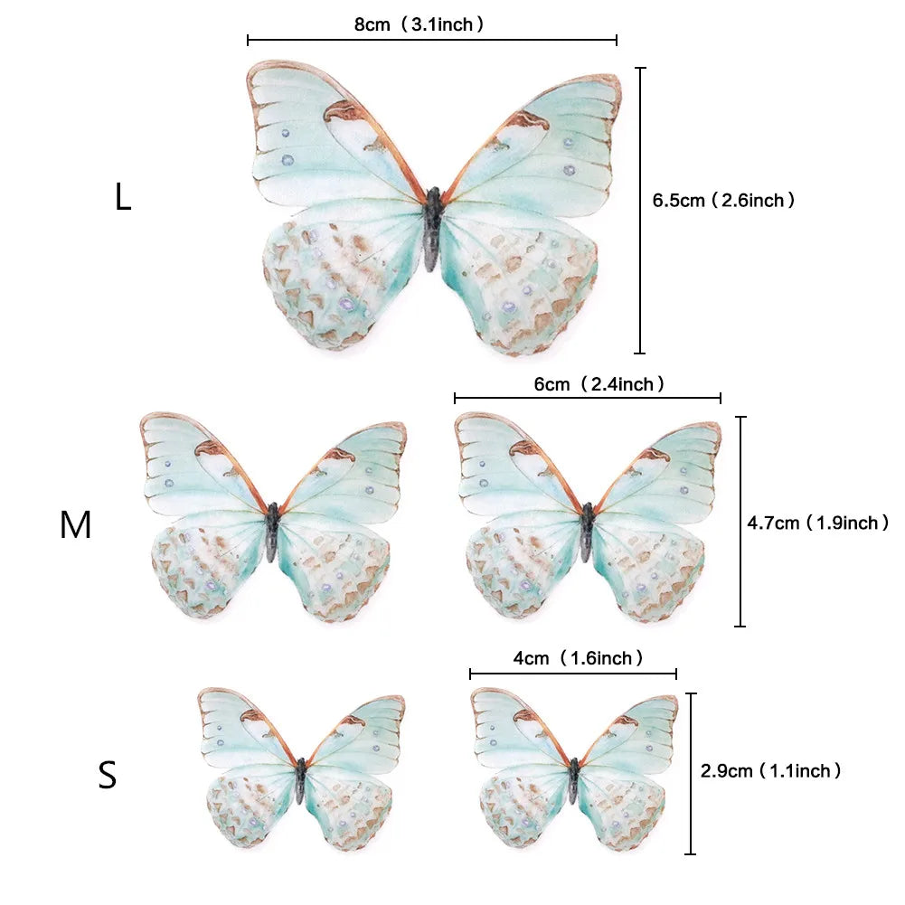Three butterfly cake toppers in large, medium, and small sizes with varying blue and orange markings