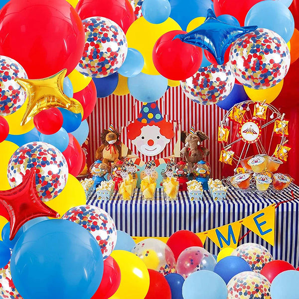 A vibrant balloon garland arch featuring red, yellow, blue, and iridescent balloons with star foil accents.
