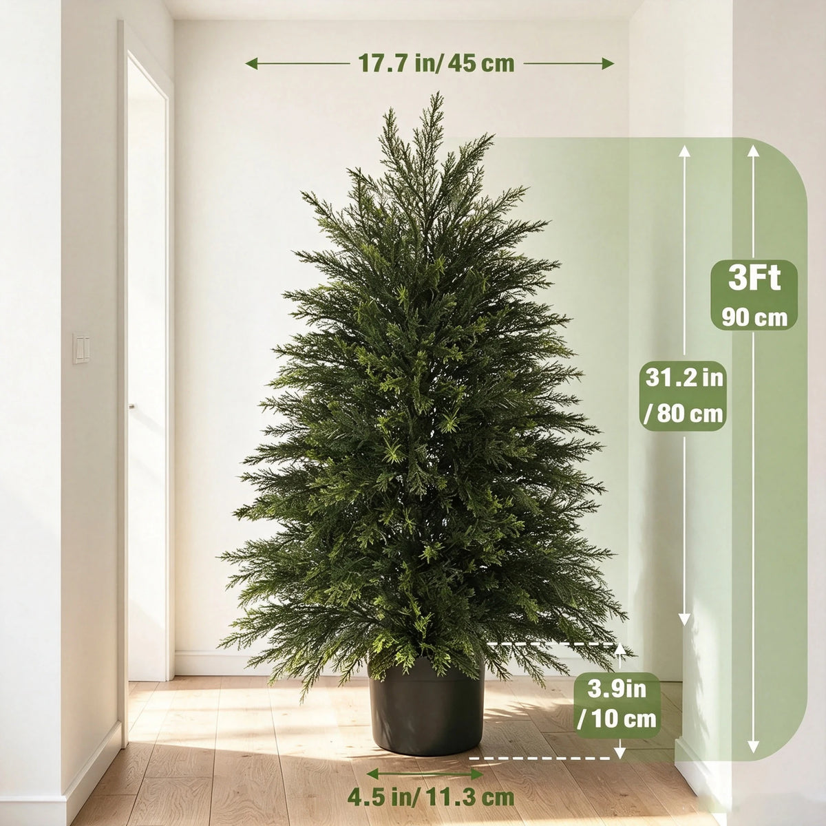 A tall artificial cedar topiary tree in a dark pot displayed indoors next to a white door.