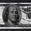 A close-up of a US $100 bill printed on a black brick wall.