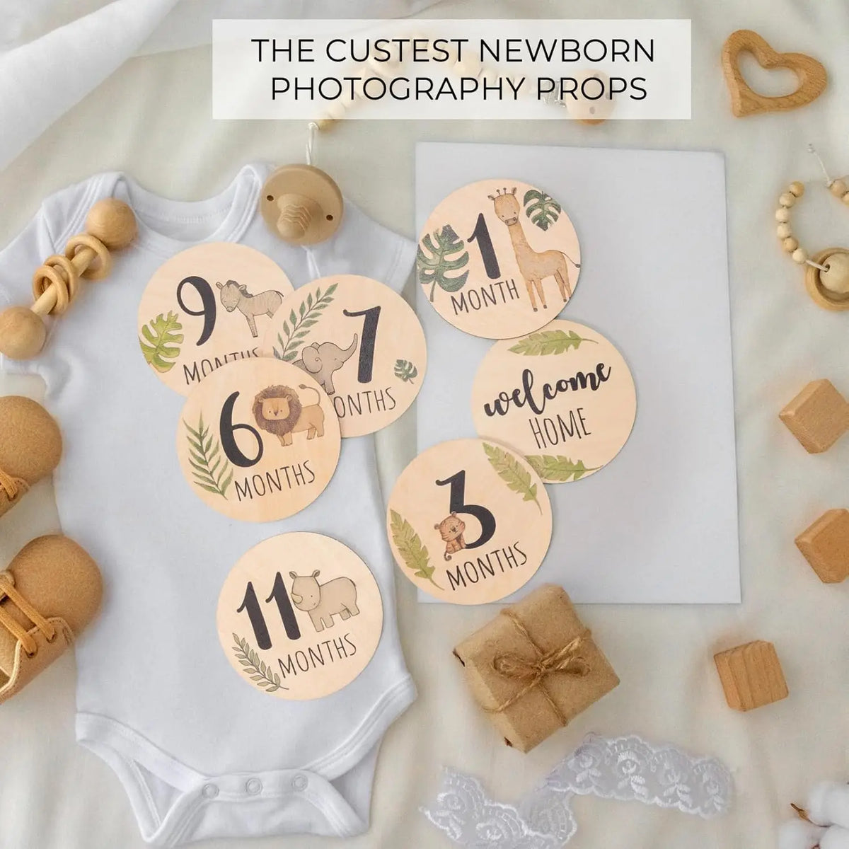 A collection of wooden signs with numbers and animals for newborn photography props on a white background