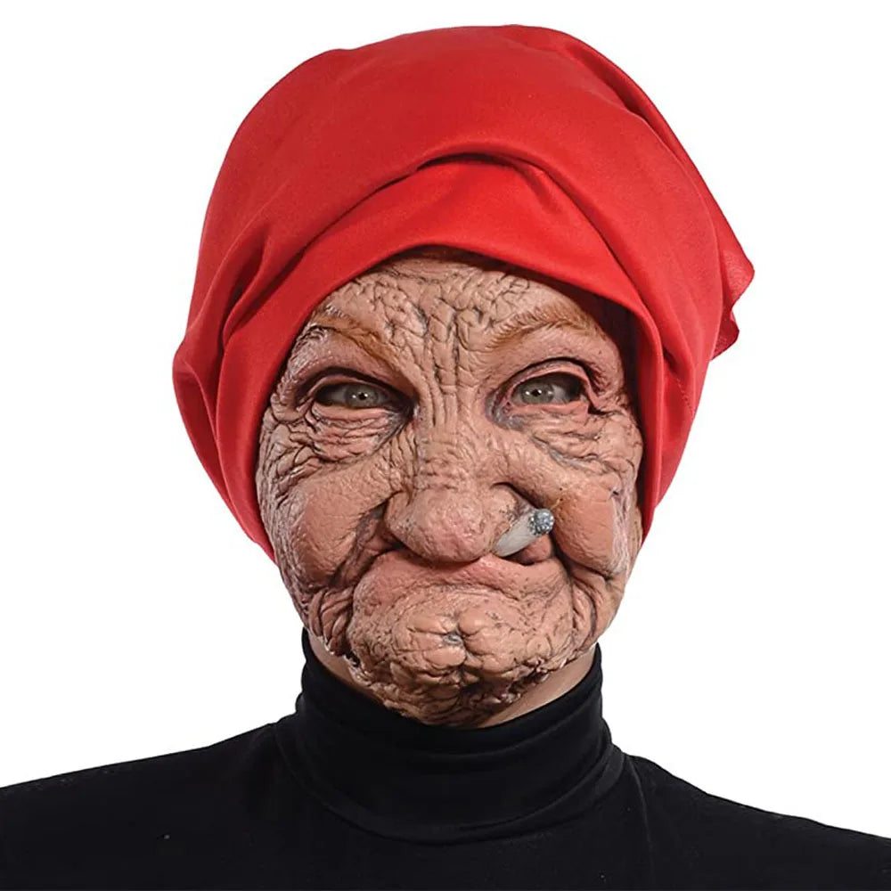 A realistic latex horror mask of an elderly woman with wrinkled skin wearing a red headscarf.