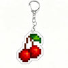 A shiny silver acrylic keychain charm shaped like a red and yellow apple.