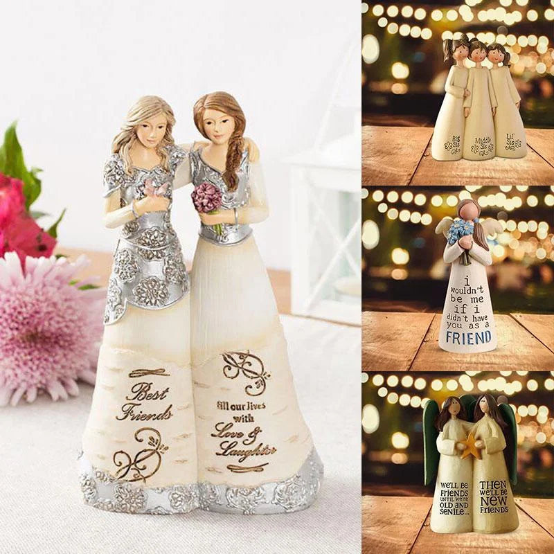 A pair of angel friendship statues in white and silver, featuring engraved text on the base.