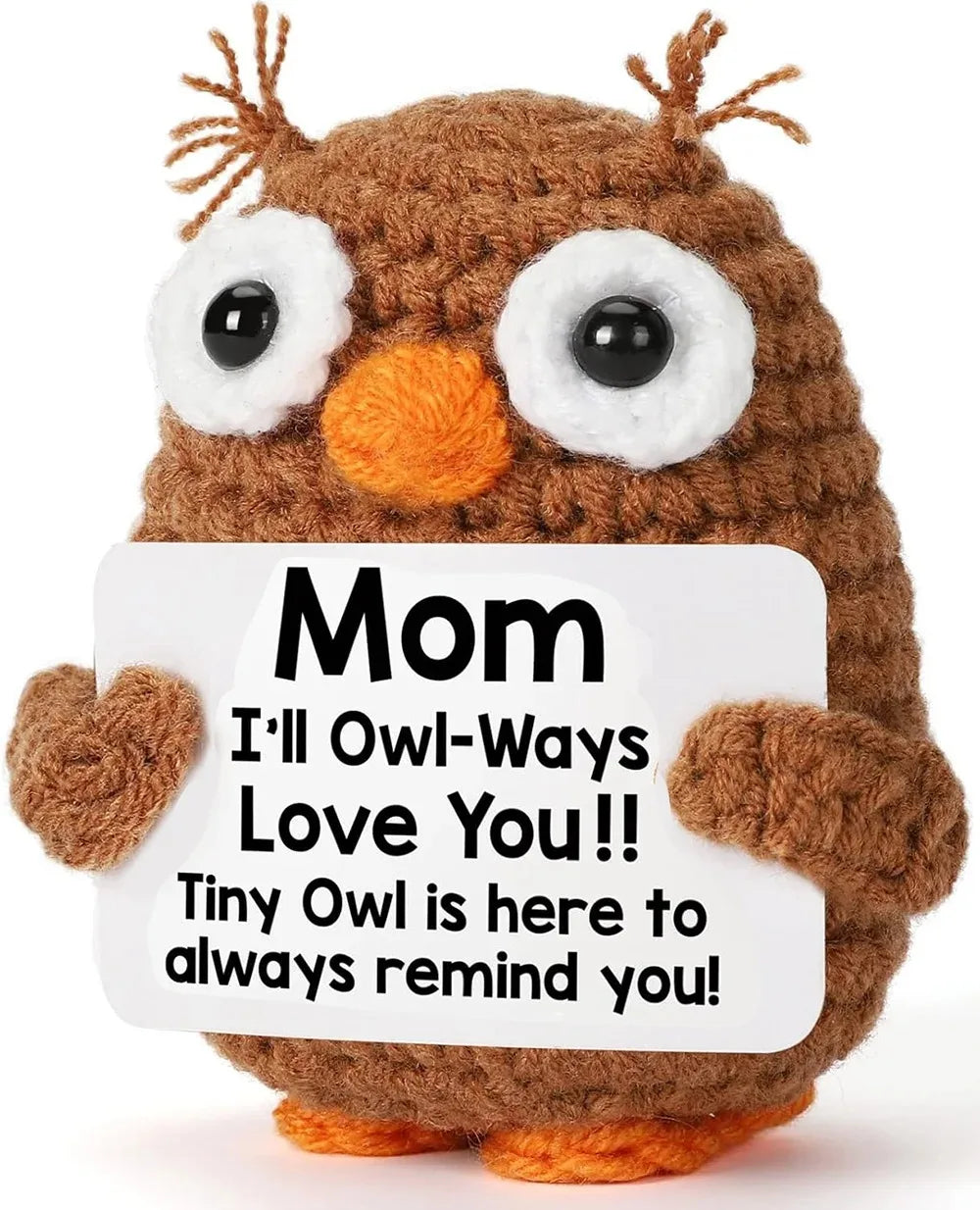 A handcrafted crochet owl doll with brown fur and large white eyes.