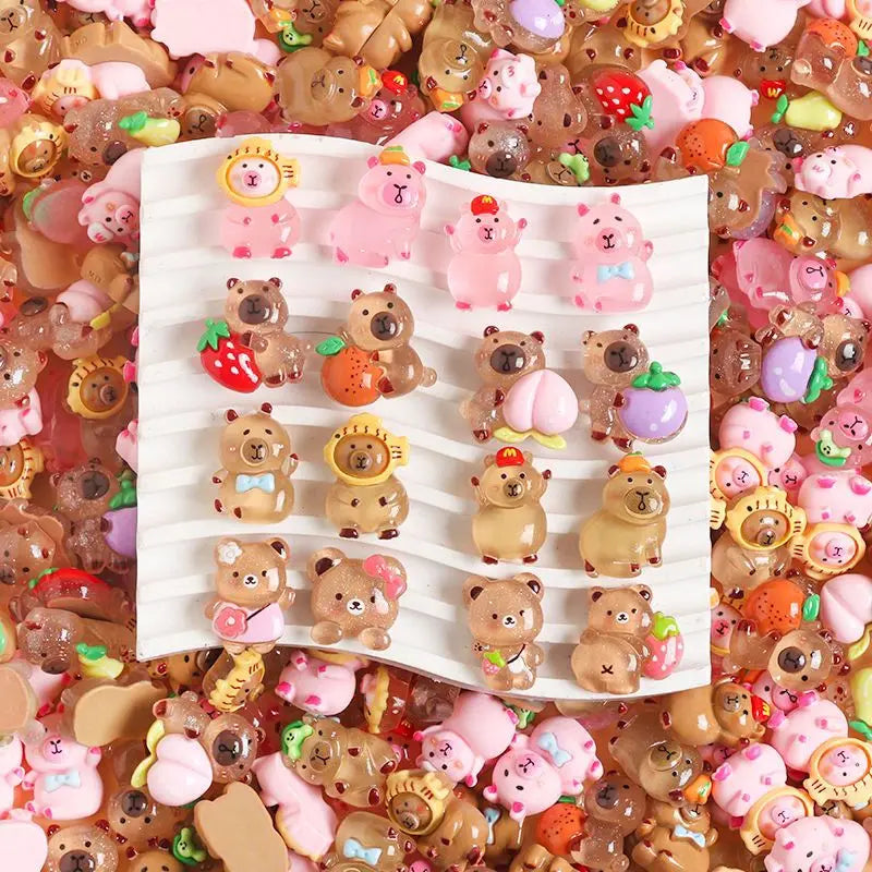 A close-up of various small, colorful, and textured miniature figures resembling capybaras in a pile.