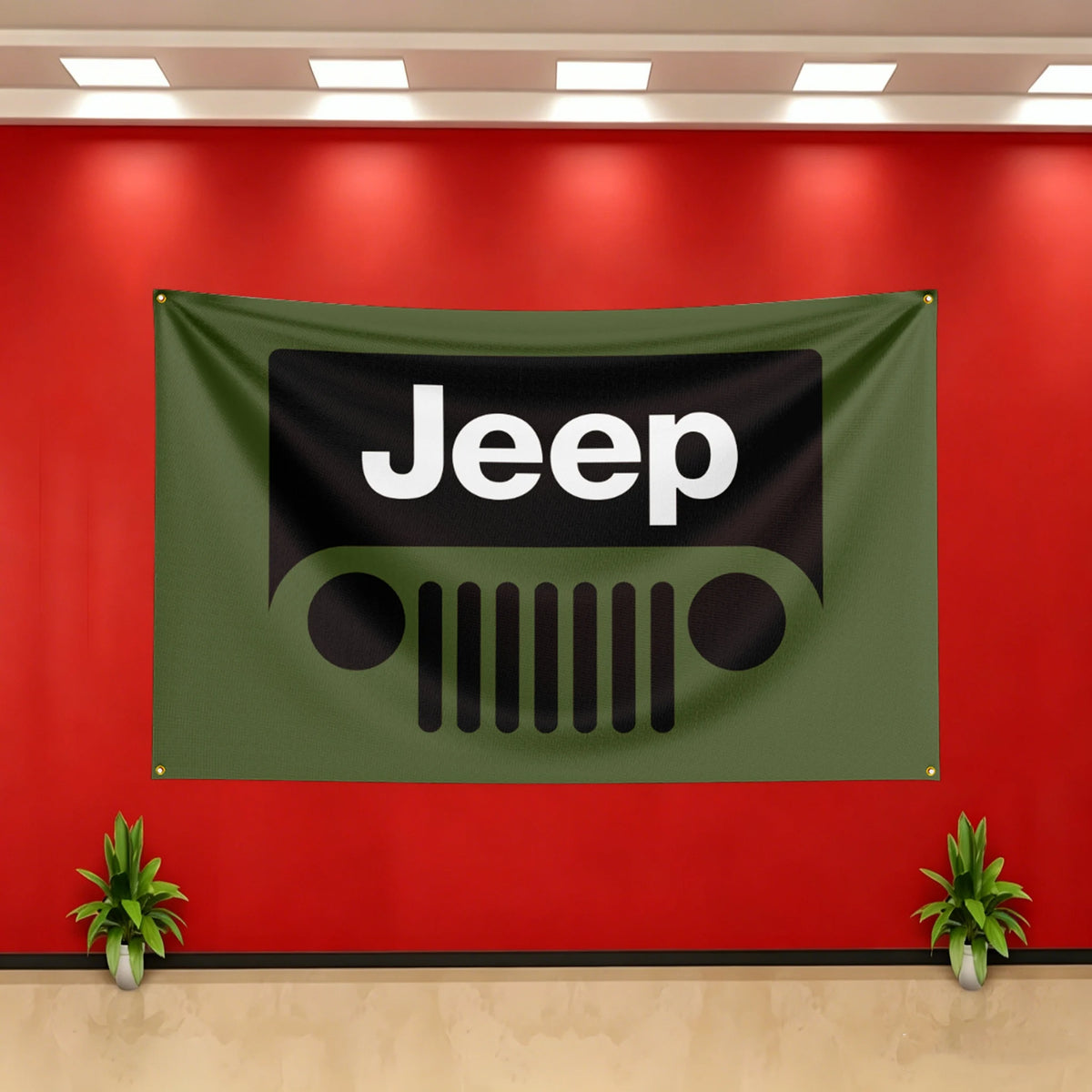 A dark olive green Jeep flag banner is displayed on a red wall with white lettering and a stylized Jeep grille logo.