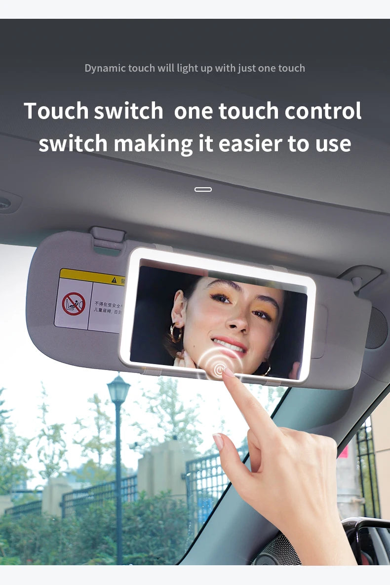 A hand touches a car sun visor vanity mirror with an LED light to switch on the display.