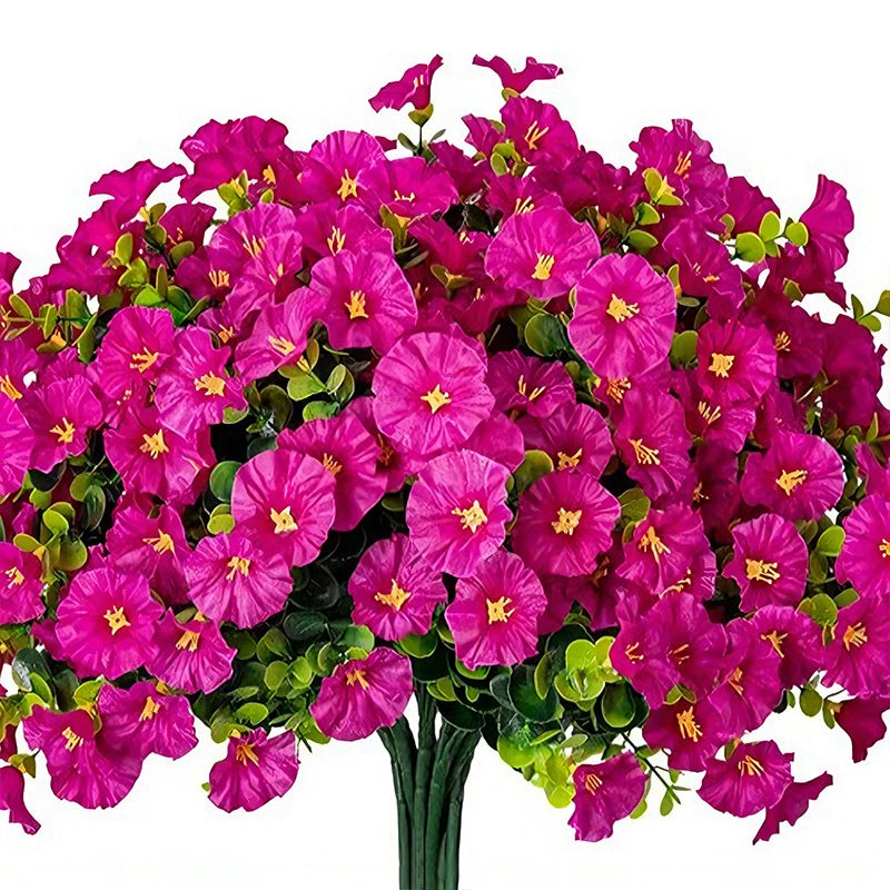 A vibrant bouquet of artificial morning glory flowers in bright pink and green eucalyptus stems.