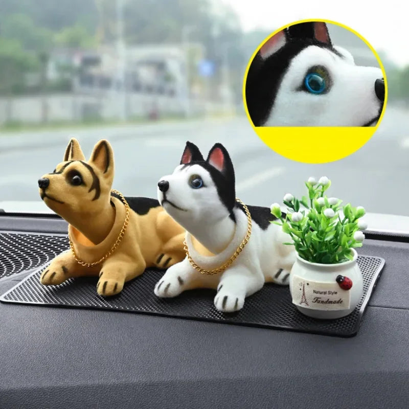 A set of multi-figure dog ornaments, including a brown and black dog and a white and black dog, displayed on a dark surface.
