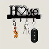 A black letter H and heart design metal wall key holder with four hooks and various keys.