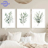 A set of three framed botanical leaf art prints featuring sage green foliage on white backgrounds.