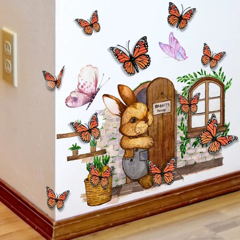A wall decal set featuring twelve orange and black monarch butterflies and a rabbit in a rustic garden scene.