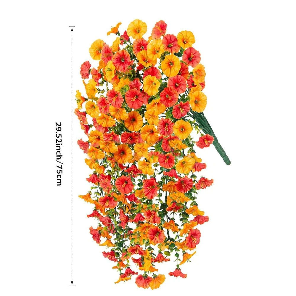 A bouquet of artificial hanging morning glory flowers in vibrant orange and red hues with green eucalyptus leaves.