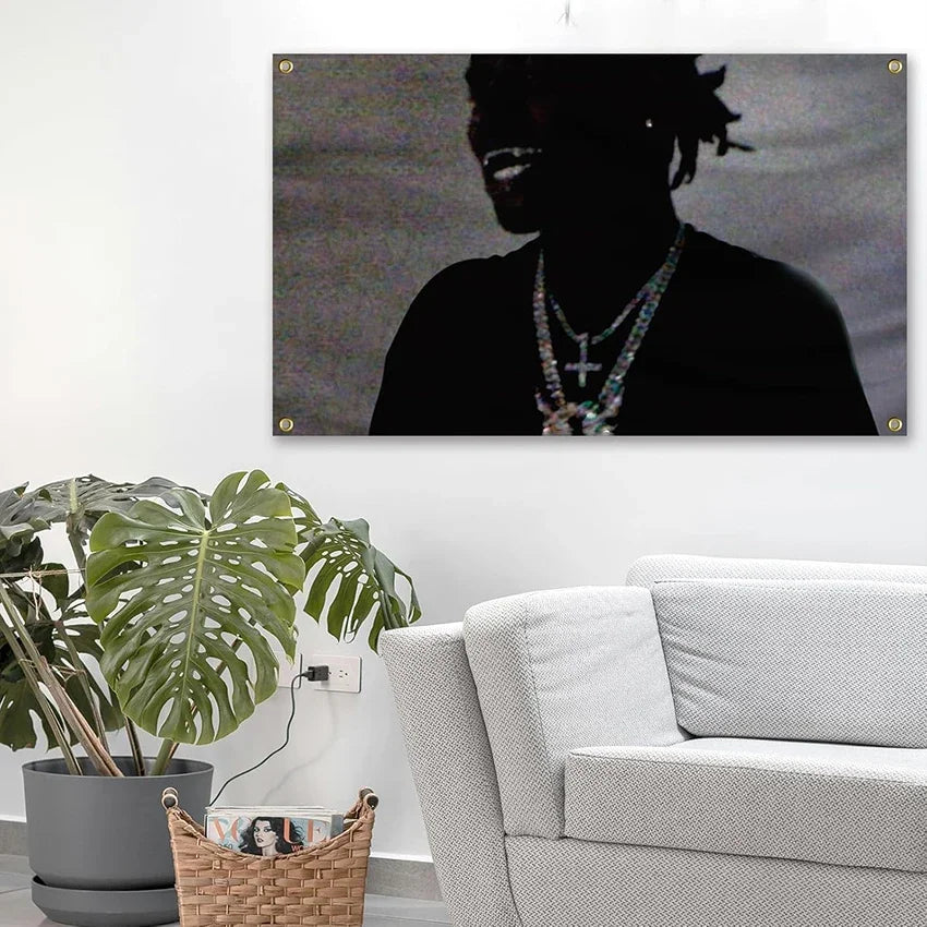 A black silhouette of a person wearing a necklace is displayed on a canvas against a light wall.