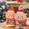 Reusable orange Christmas gift bags filled with treats and party favors