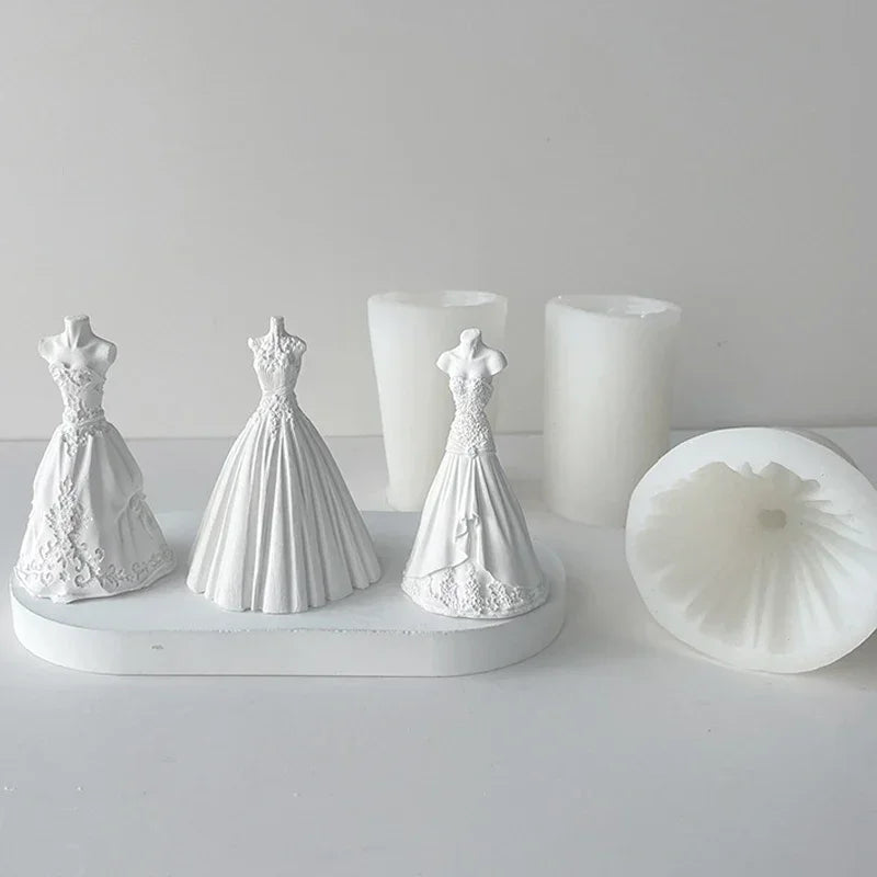 White silicone molds shaped like wedding dresses used for making candles and chocolate