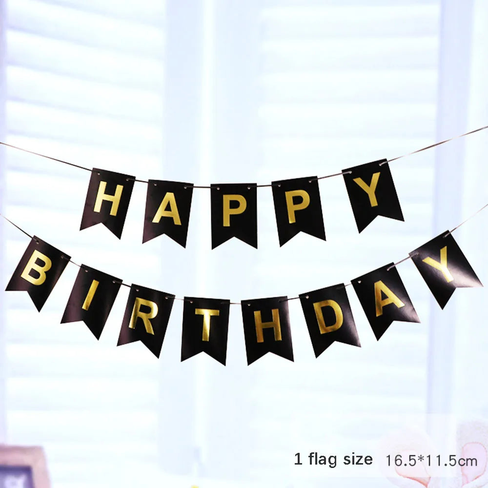 Black and gold pennant banner spelling out Happy Birthday strung across a bright window