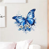 A watercolor painting of a blue butterfly with blue and yellow floral accents on a white wall.