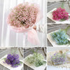 A bouquet of pink artificial gypsophila flowers in a sheer pink wrapping, displayed alongside various arrangements.