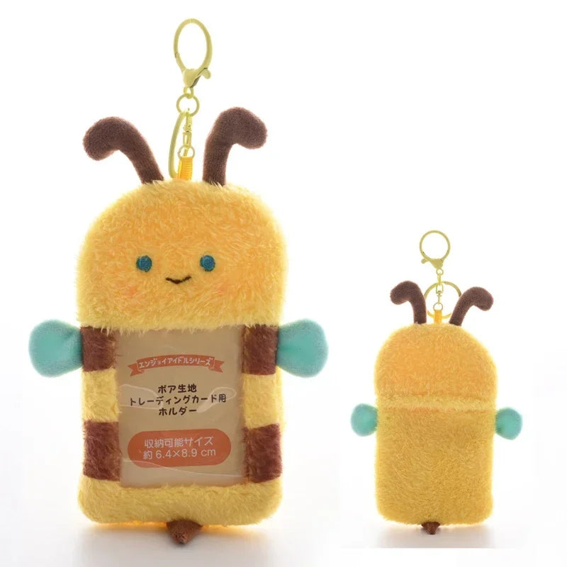A yellow, bee-shaped keychain with brown stripes and blue wings.