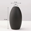 A matte black ceramic vase with an egg shape, shown against a white background.