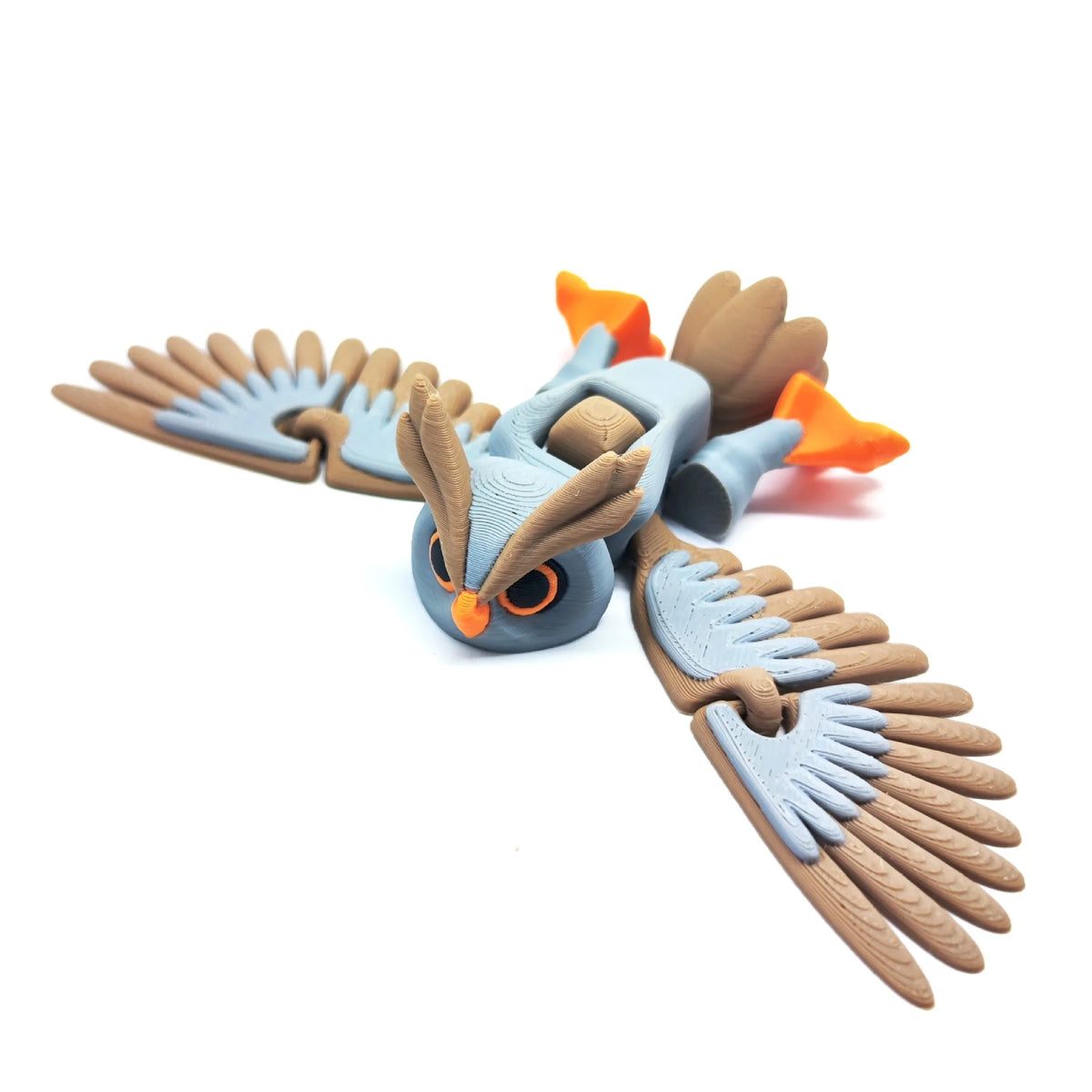 A detailed 3D printed owl figurine with orange accents and brown feathers, designed as a desk decor.
