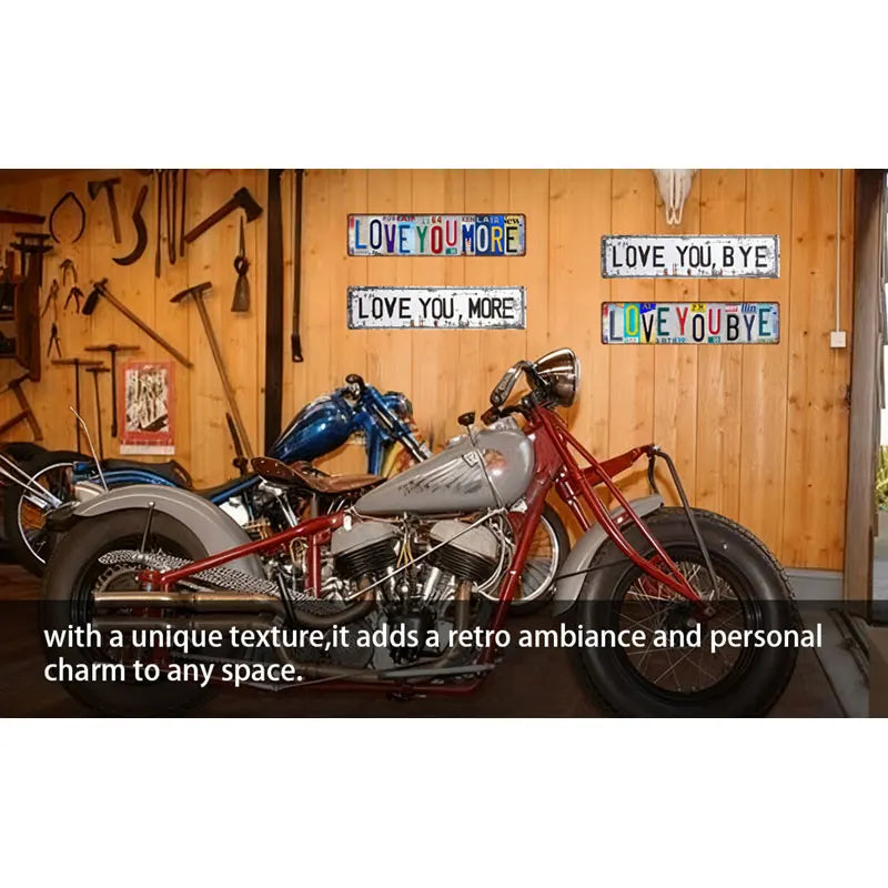 A vintage motorcycle with a custom paint job is displayed against a wooden wall decorated with love and goodbye signs.