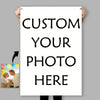 A white sign with black text that reads Custom Your Photo Here, held up by a person.
