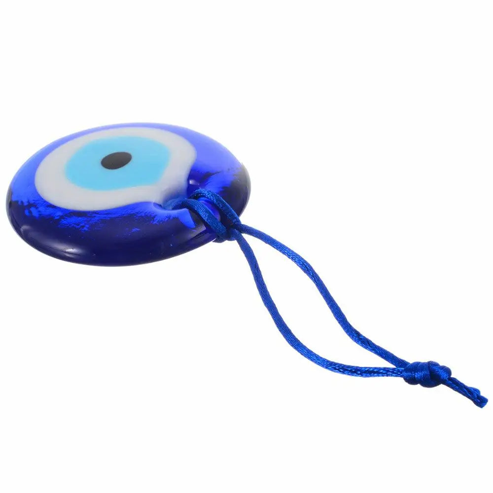 A blue glass evil eye amulet pendant with a white and blue iris design on a thin string.