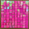 A grid of iridescent pink and magenta sequin shimmer wall panels used as a sparkling backdrop.