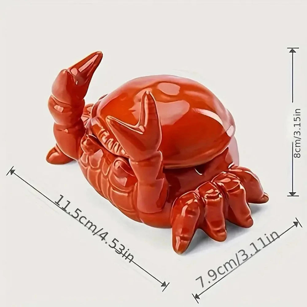 A glossy orange ceramic crab ashtray with a lid shown from above and to the side.