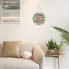 A round wooden wall plaque featuring the Spanish quote El tiempo de Dios es perfecto, displayed on a white wall.