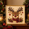 A framed piece of pearl and diamond painting featuring a deer head with antlers and festive greenery.