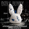 A white bunny plush keychain with blue accents is displayed against a dark background.