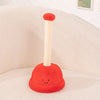 A plush toy shaped like a toilet paper poop plunger, colored bright red and cream.