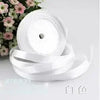 Roll of white silk satin ribbon with a central hole