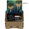 A wooden music box featuring an anime character design, likely from Detective Conan, with a metal mechanism inside.