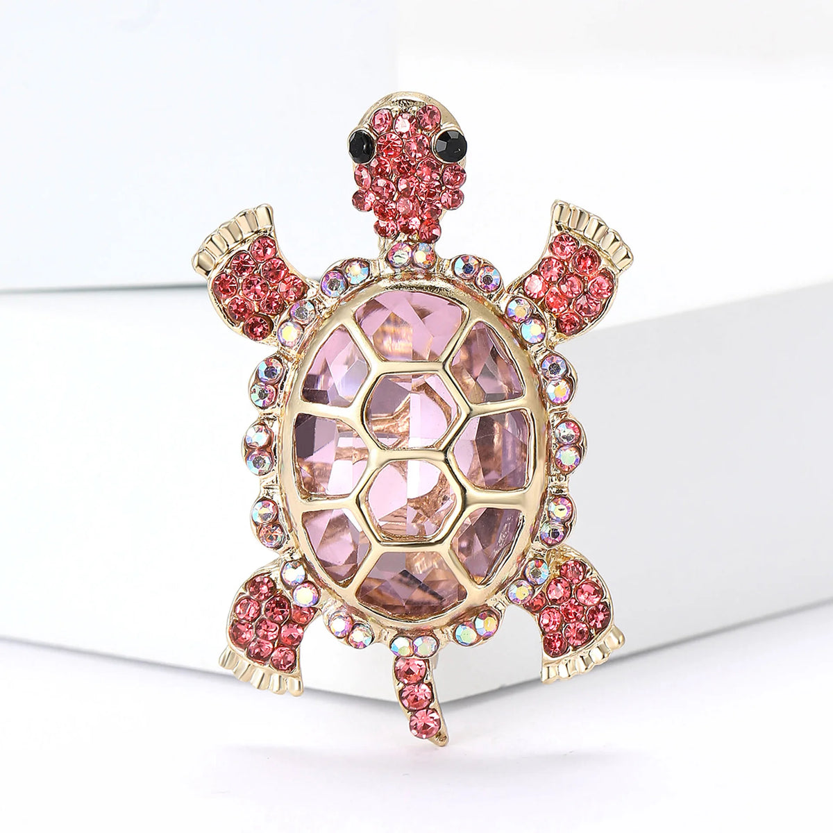A vintage marine life brooch pin set featuring a pink and gold turtle design with sparkling accents.