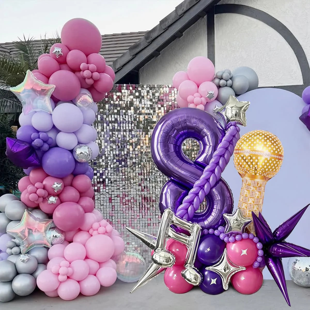 A collection of pink and purple balloons shaped like the number eight and various stars