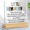 An acrylic desk sign with a positive message listing several encouraging phrases like You are enough and Be kinder to yoursel