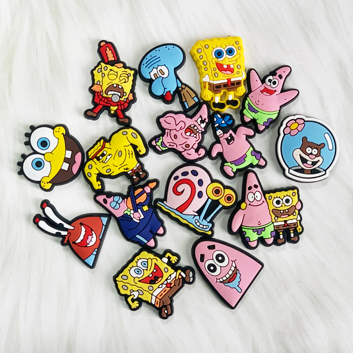 A collection of colorful SpongeBob SquarePants character shoe charms on a white background.